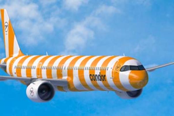 Yellow and white striped airplane in the air