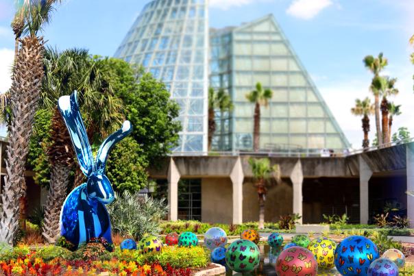 Rabbit and easter eggs in front of greenhouse