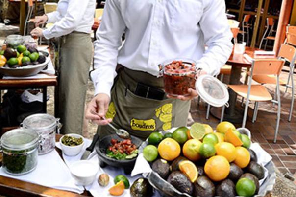 Waiter making guacamole at table at Boudro's Texas Bistro.