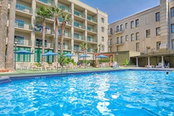 Bright blue hotel pool outside Historic Menger Hotel.